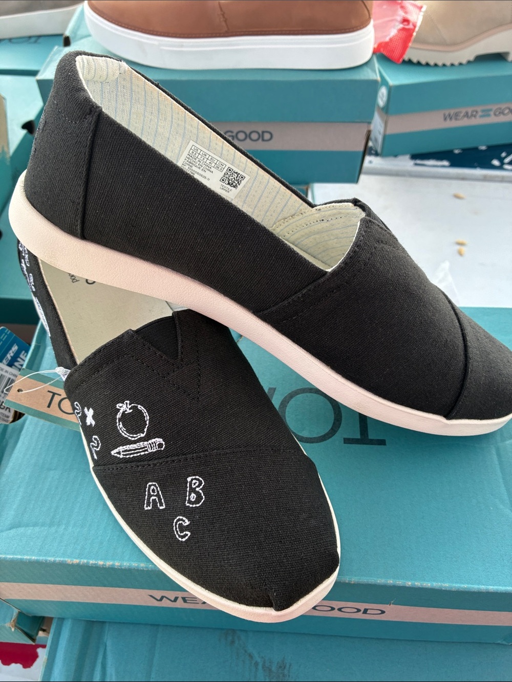 TOMS Black Canvas Slip-Ons with Light Pink Sole and White Embroidery